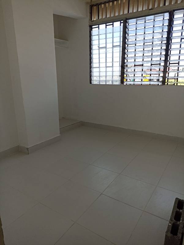 Bedroom with big window, security bars and tiled floors in Santa Ana Panama affordable apartment