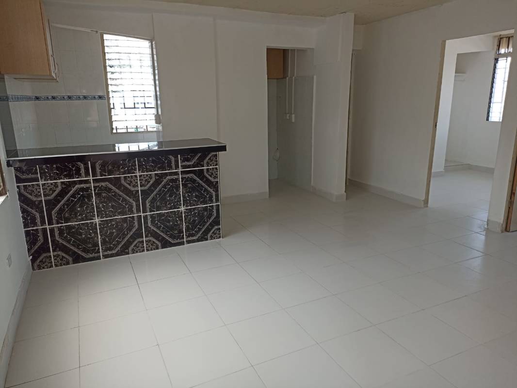 Living room with large window/bars, ceramic floors in Santa Ana affordable apartment