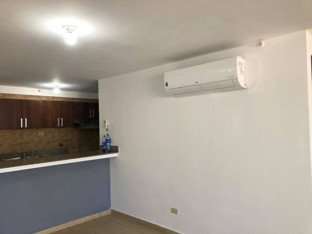 Kitchen with granite countertop, wooden cabinets and split AC in apartment for rent Panama