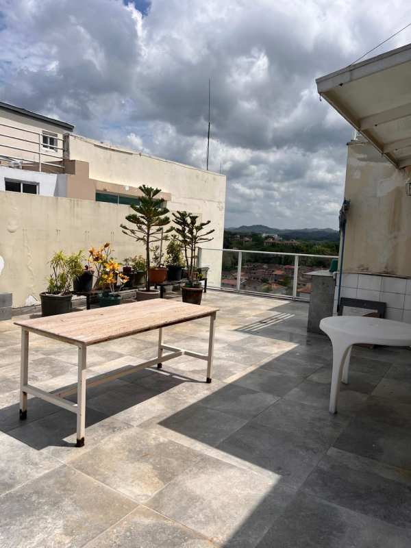 Rooftop terrace with tiles, plants, glass railing overlooking greenery in PH Pine Hill Panama