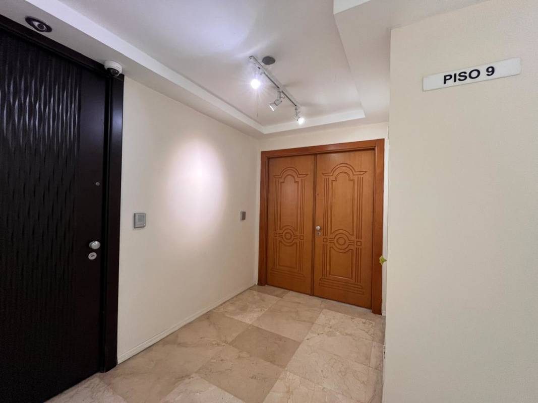 Hallway with double wooden doors and marble tiles PH Pine Hill Penthouse Panama