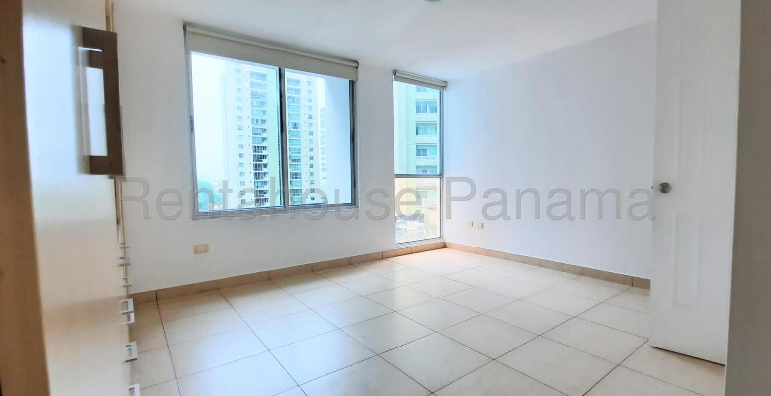 Spacious living room with large windows and city view in apartment Green Bay Tower Costa del Este