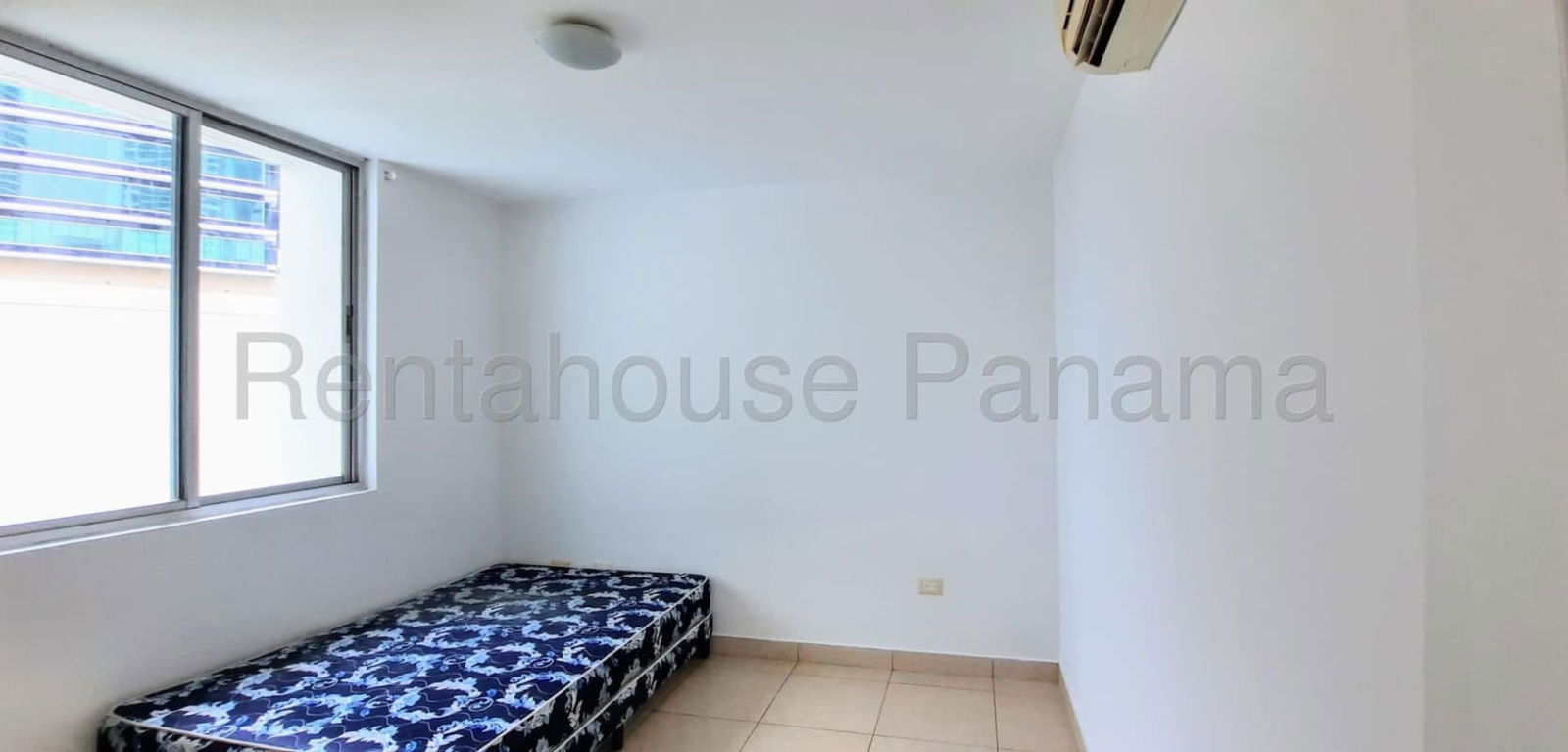 Bedroom with large windows and built-in wardrobe in apartment Green Bay Costa del Este Panama