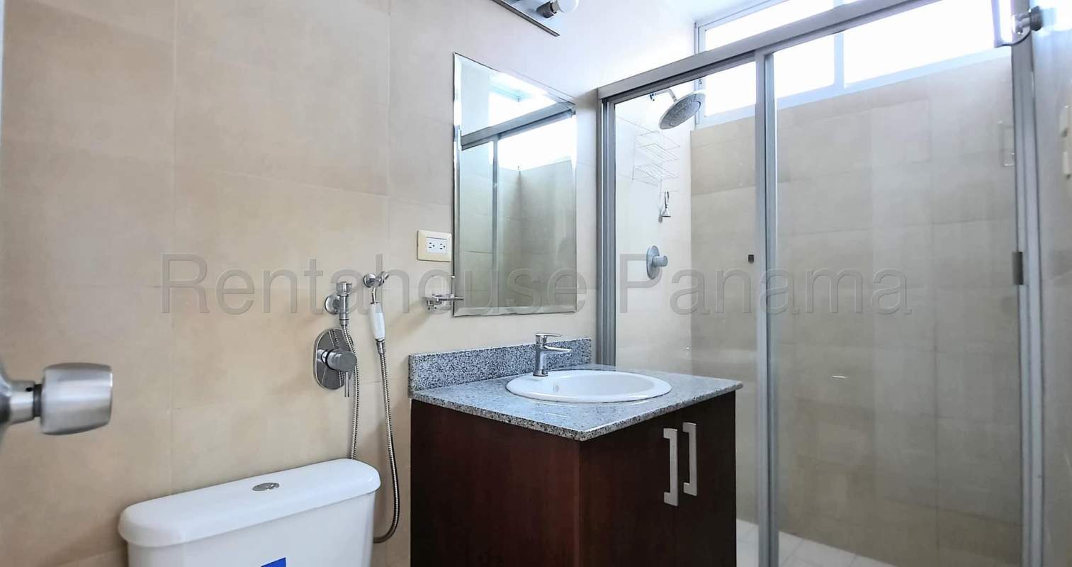 Modern bathroom with granite countertop and glass-enclosed shower Costa del Este apartment