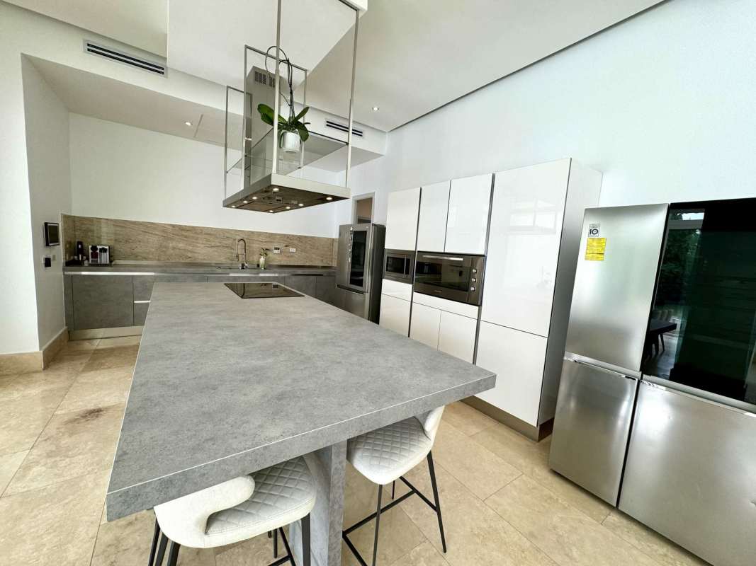 High-end kitchen with granite counters, island breakfast bar in Fairway Estates Santa María Golf Panama
