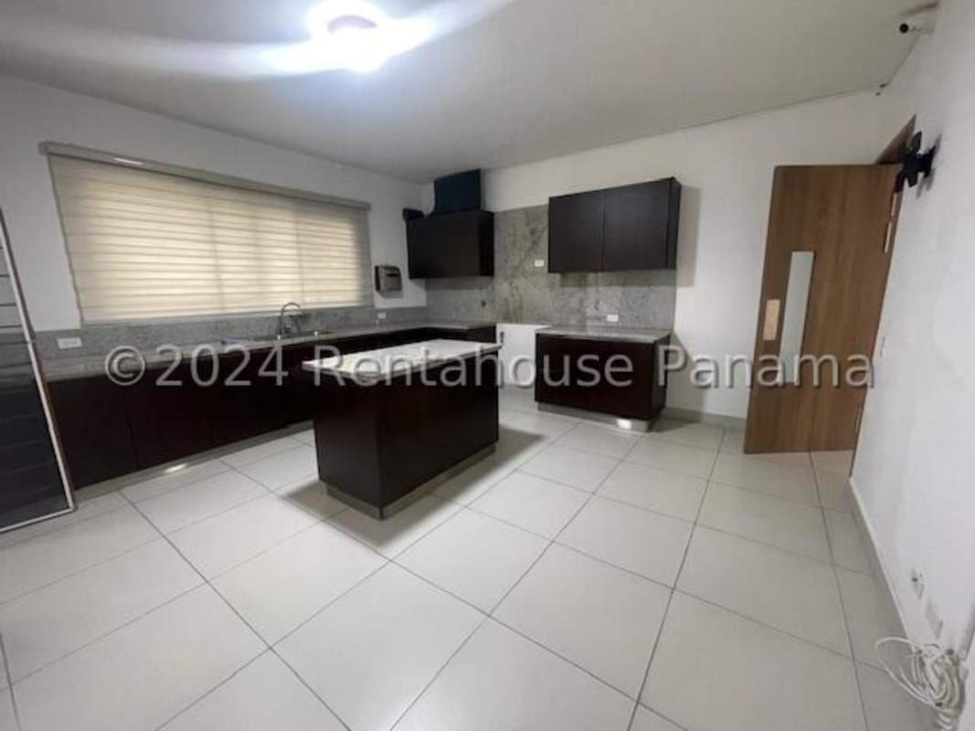 Spacious covered terrace with tiled floor and view to fenced backyard