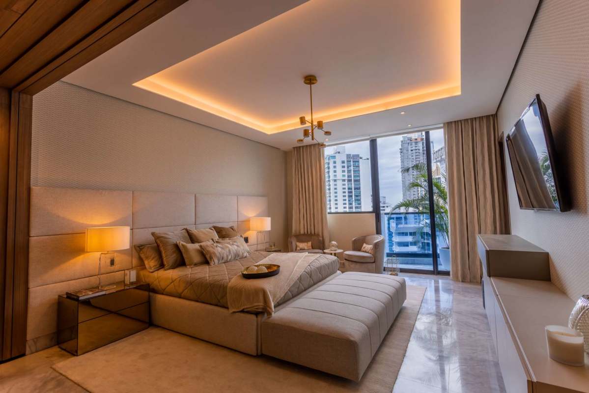 Elegant master bedroom with upholstered headboard floor-to-ceiling windows city view PH Ocean Front Punta Paitilla