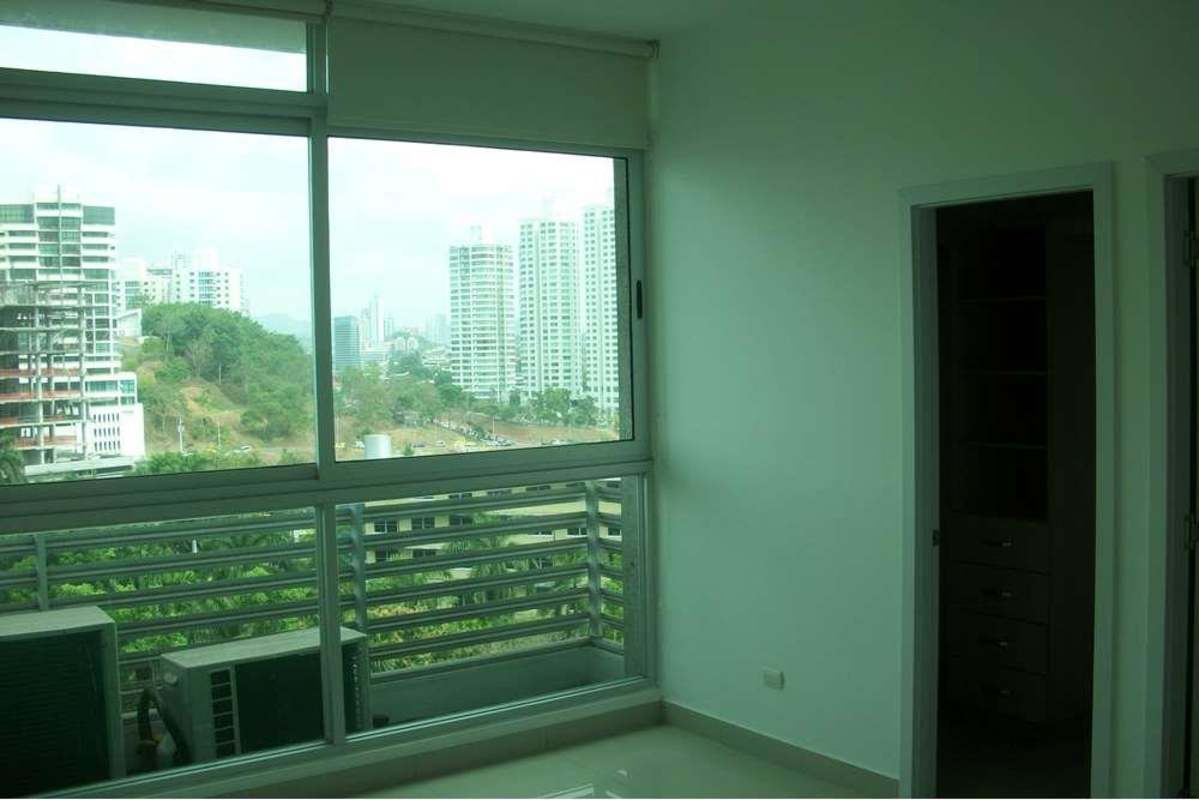 Large bedroom with windows offering city skyline view in PH Yoo Panama