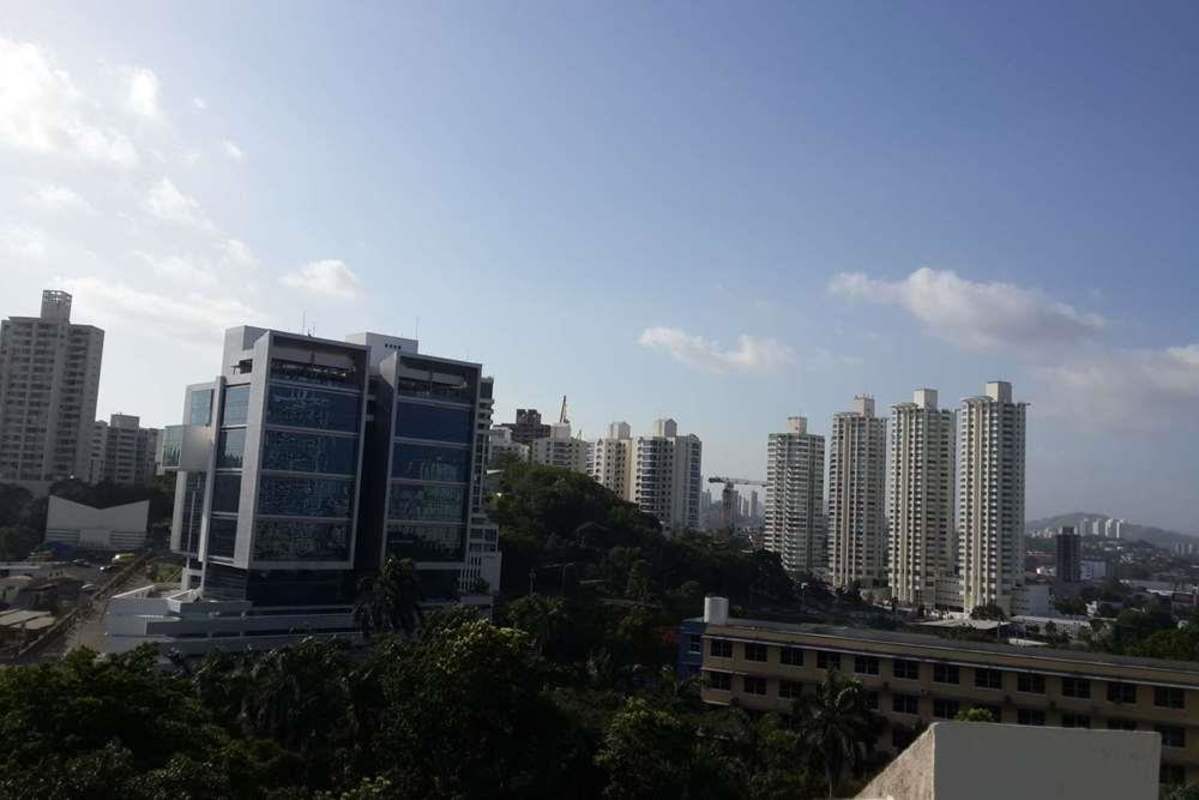 Living room with floor-to-ceiling windows city skyline PH Yoo Bella Vista
