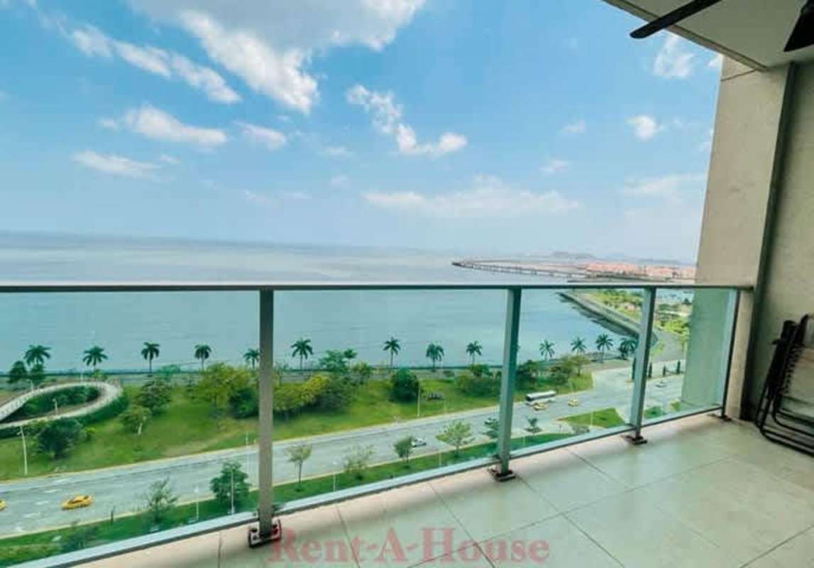 Modern home office area with floor to ceiling windows ocean and city views