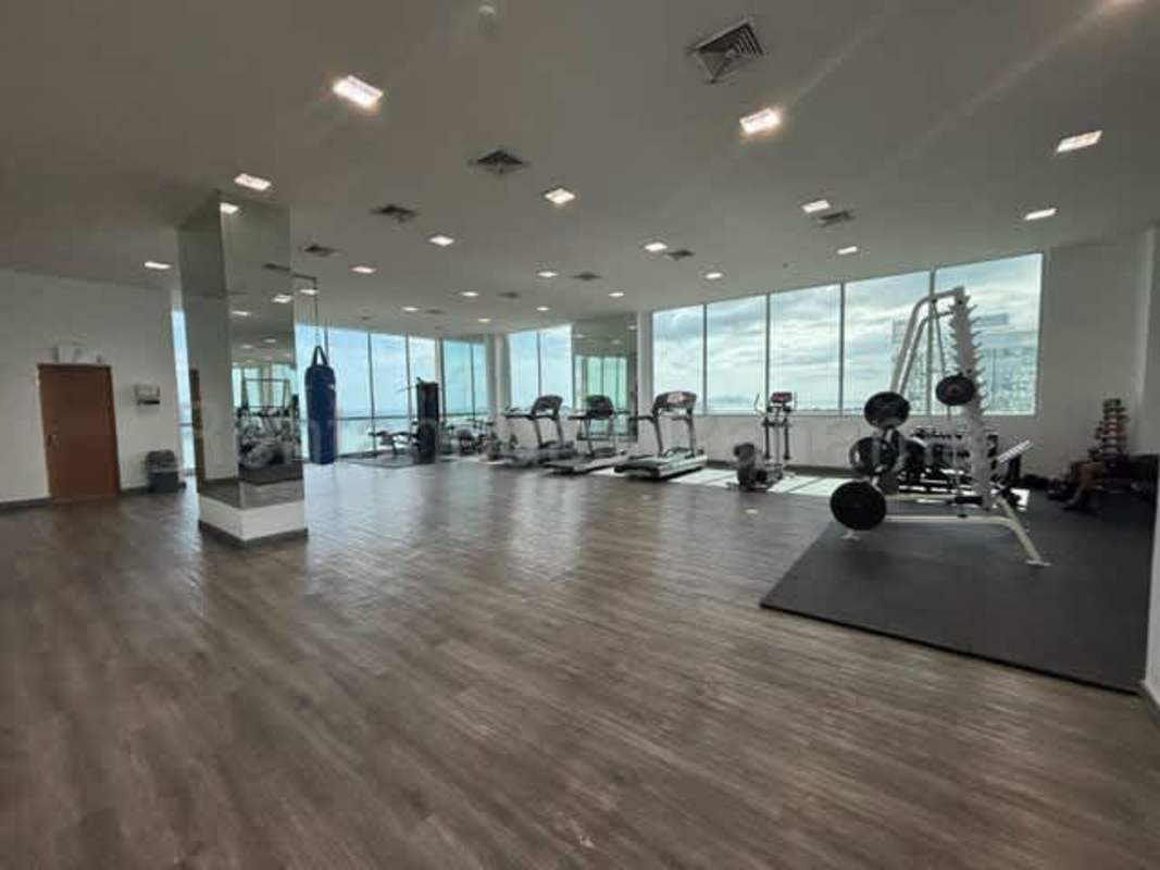 Modern gym with cardio and weights overlooking bay at PH Yacht Club Panama