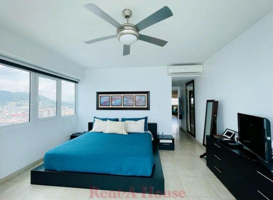 Modern bedroom with large windows and skyline views PH Yacht Club Residences Panama