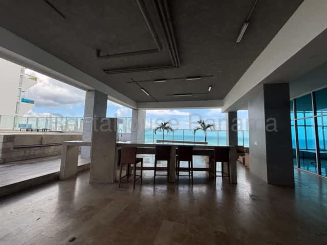 Covered terrace with ocean views and bar lounge seating PH Yacht Club Residences Panama