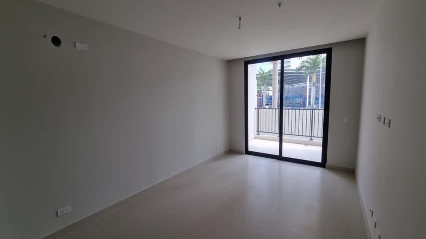 Bright living and dining area with floor-to-ceiling windows and balcony access at PH Costa del Este Panama