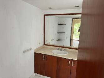 Covered outdoor patio with built-in barbecue and tropical garden views inside Mantaraya golf community Panama