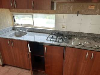 Kitchen with granite countertops, wooden cabinets, breakfast bar in townhouse at Royal Decameron Panama