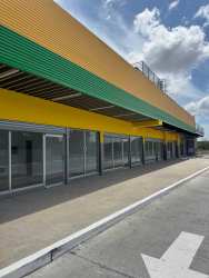 Street view exterior with parking area glass windows colorful facade at Super Mr Precio Las Mendozas