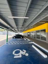 Covered parking area with handicap access in front of retail commercial units Costa Verde La Chorrera