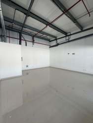 Flexible interior retail or office space with polished floors and high ceiling at Super Mr. Precio Las Mendozas