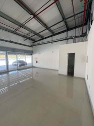 Industrial-style interior with large glass windows open space polished concrete floors in Costa Verde Panama