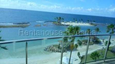 Sandy beach with palm trees and blue ocean at Playa Escondida Maria Chiquita Panama