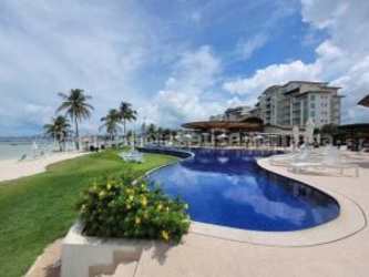 Ocean-facing balcony with outdoor seating and glass railing at Playa Escondida Panama