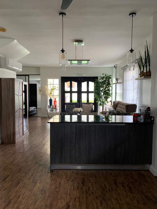 Living room with open floor plan, entry doors at Villa Valencia Costa Sur Panama