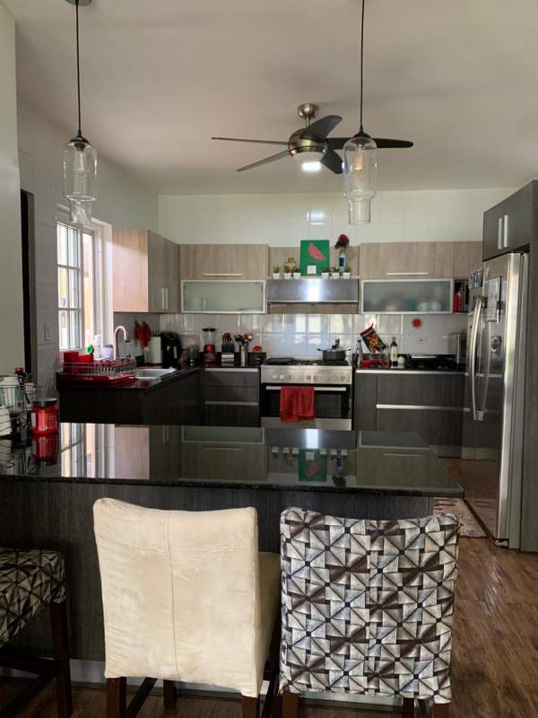 Remodeled kitchen with granite island, stainless appliances in Villa Valencia townhouse Costa Sur Panama