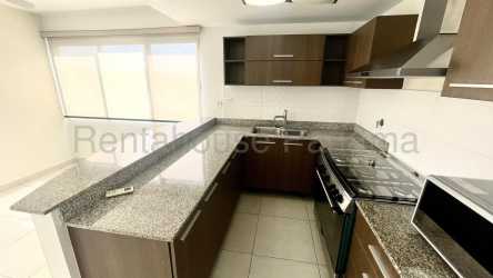 Bright living dining room with big windows, balcony access, and ceramic floors in Woodland Panama Pacifico