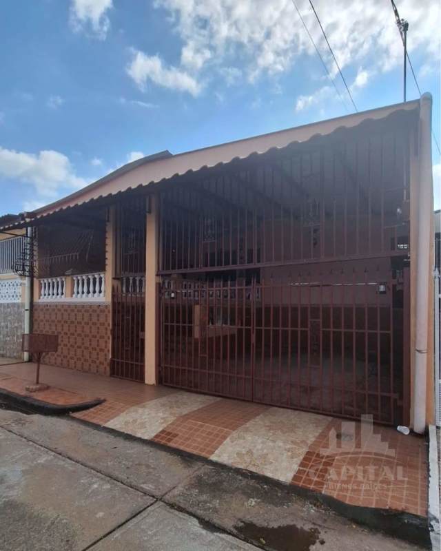 Kitchen with granite countertops, textured wall tile, window and outdoor access in Don Bosco Panama