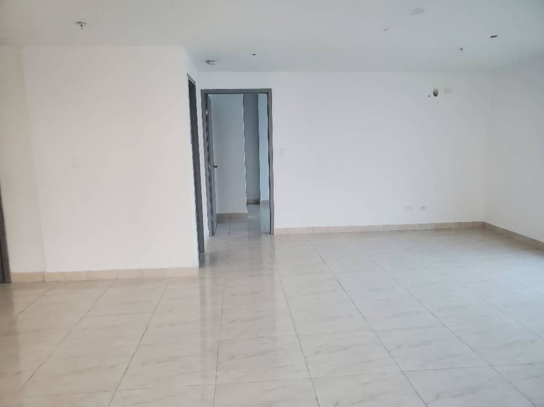 Bedroom with large window showing city skyline and water PH The Sands Panama