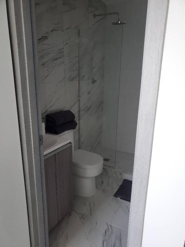 Elegant marble bathroom with glass shower enclosure at PH The Sands