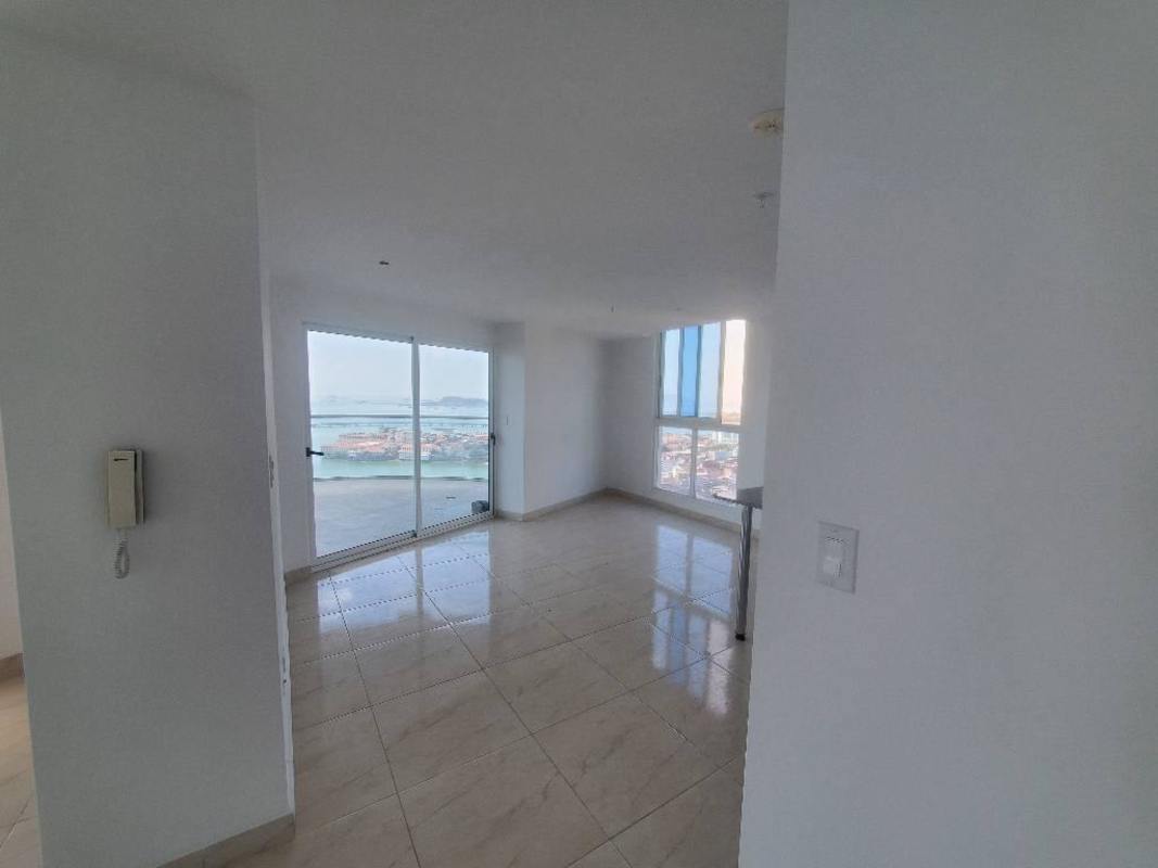 Living room with sliding doors, city skyline, belt coastal highway view PH The Sands Panama