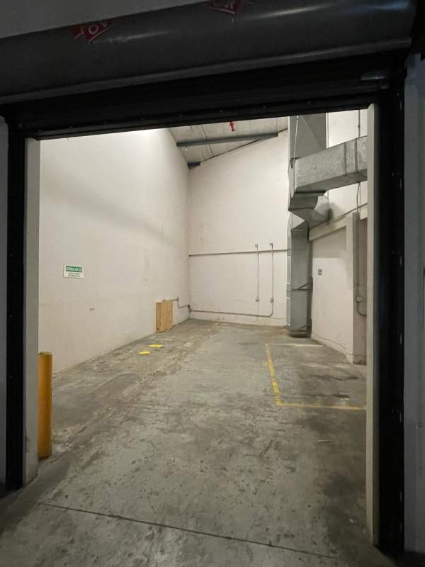 Small kitchenette area with granite counter and steel sink in warehouse in Free Zone Panama