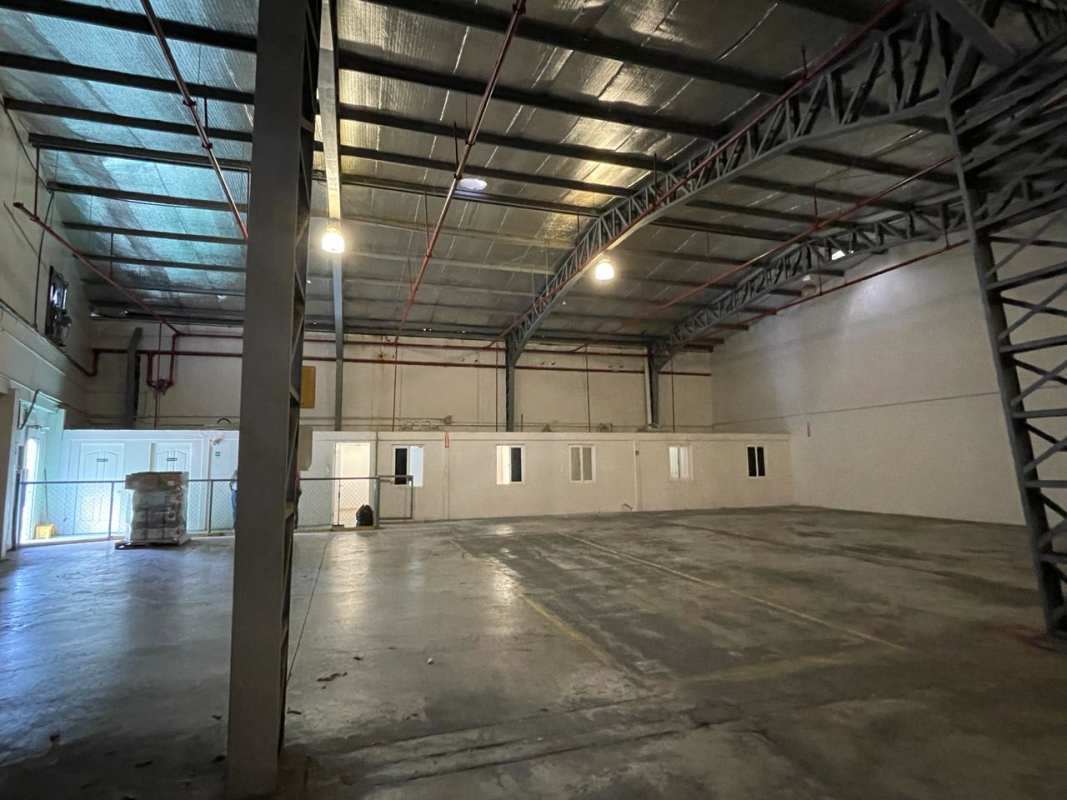 Empty warehouse with concrete floor, ventilation ducts, overhead lighting in Albrook Free Zone Panama