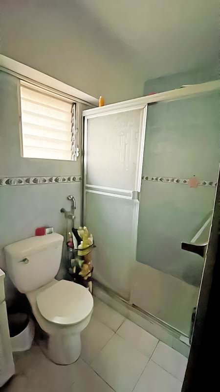 Compact bathroom with shower, glass enclosure, blue tiles and window Plaza Bella Vista La Cresta