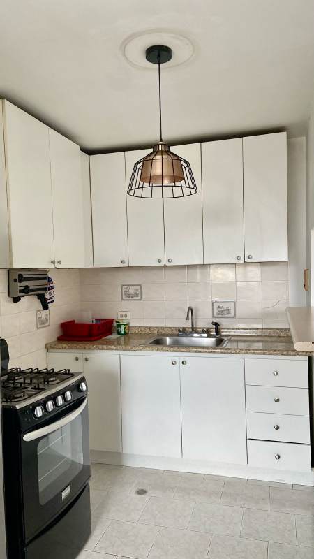 Laundry area with washer, water heater, and window views PH Parque Lefevre