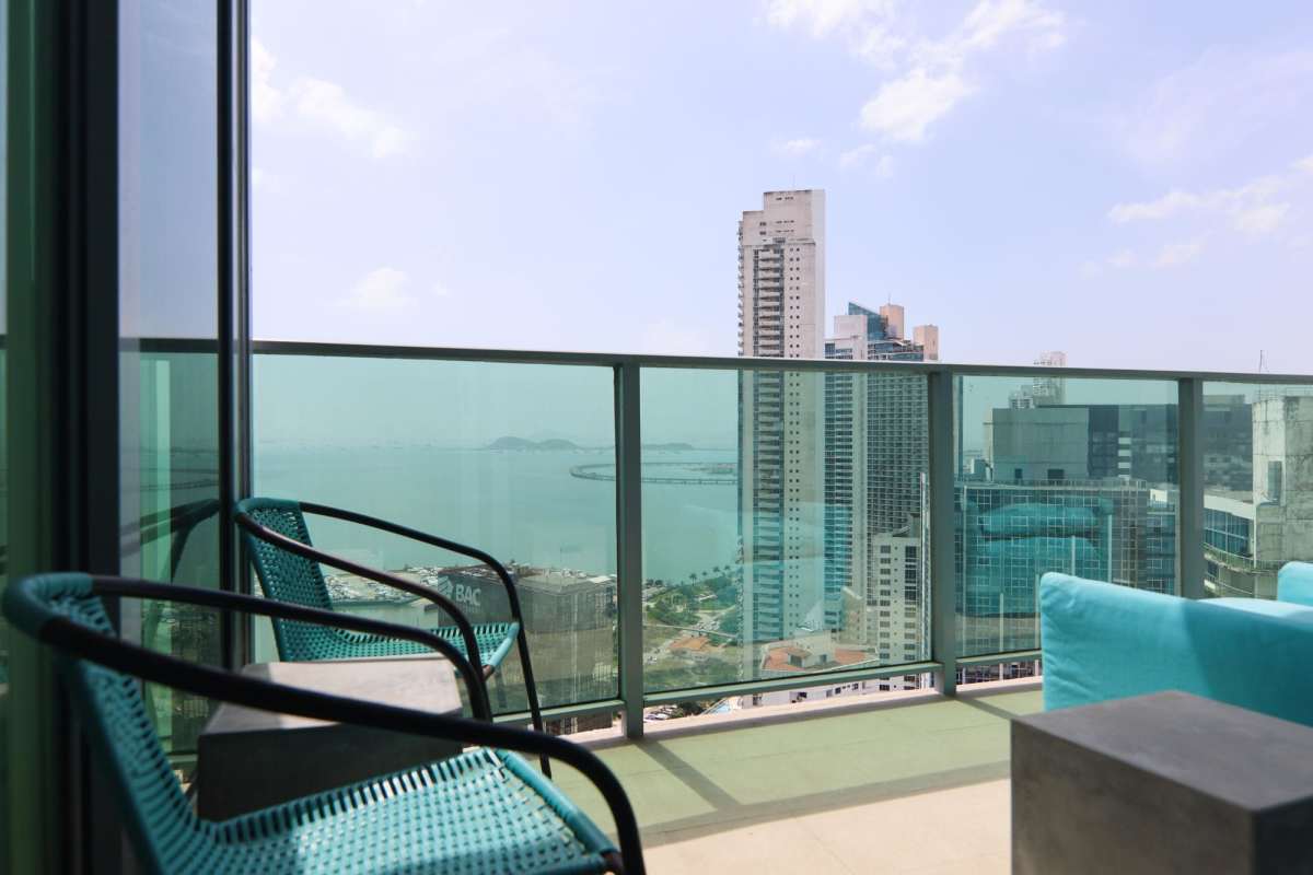 Luxury semi-open kitchen with island and stainless steel appliances in Allure at the Park penthouse Panama