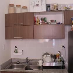 Compact kitchen area with wooden cabinets and granite in Los Álamos La Chorrera