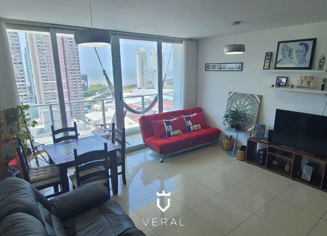 Open concept dining and living room with skyline views, marble floors, modern furnishings in PH Top Tower Panama
