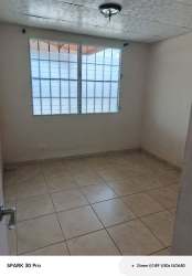 Bright bedroom with large window security bars and tile floors house for rent Brisas del Golf Arraiján Panama