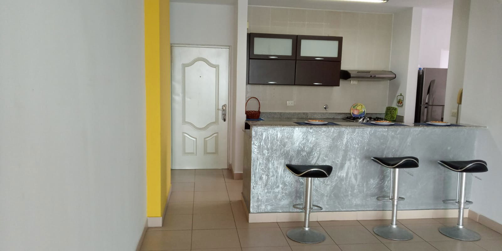 Contemporary kitchen with breakfast bar, granite countertops, appliances in PH San Francisco Panama apartment