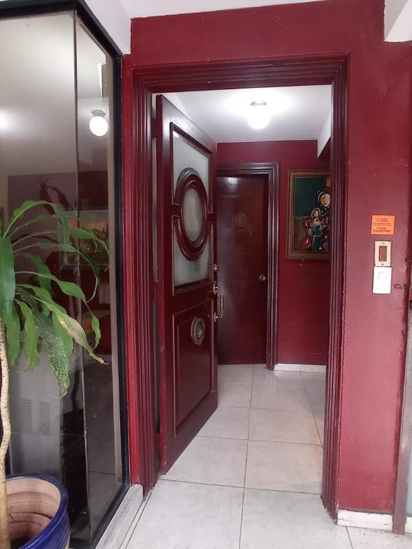 Bright living room with staircase and wall art in 3-story house Los Ángeles Panama for sale