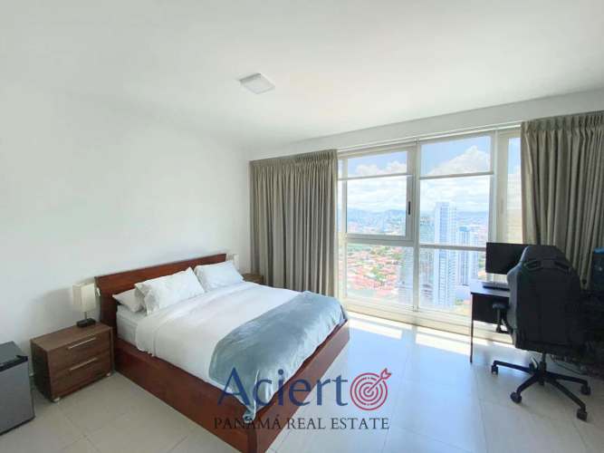 Spacious bedroom with large windows, panoramic city view and minimalist decor at Quartier Boutique Coco del Mar Panama City