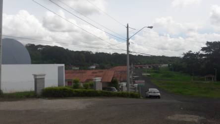 Suburban neighborhood access with residential houses and natural greenery near 5 hectare land