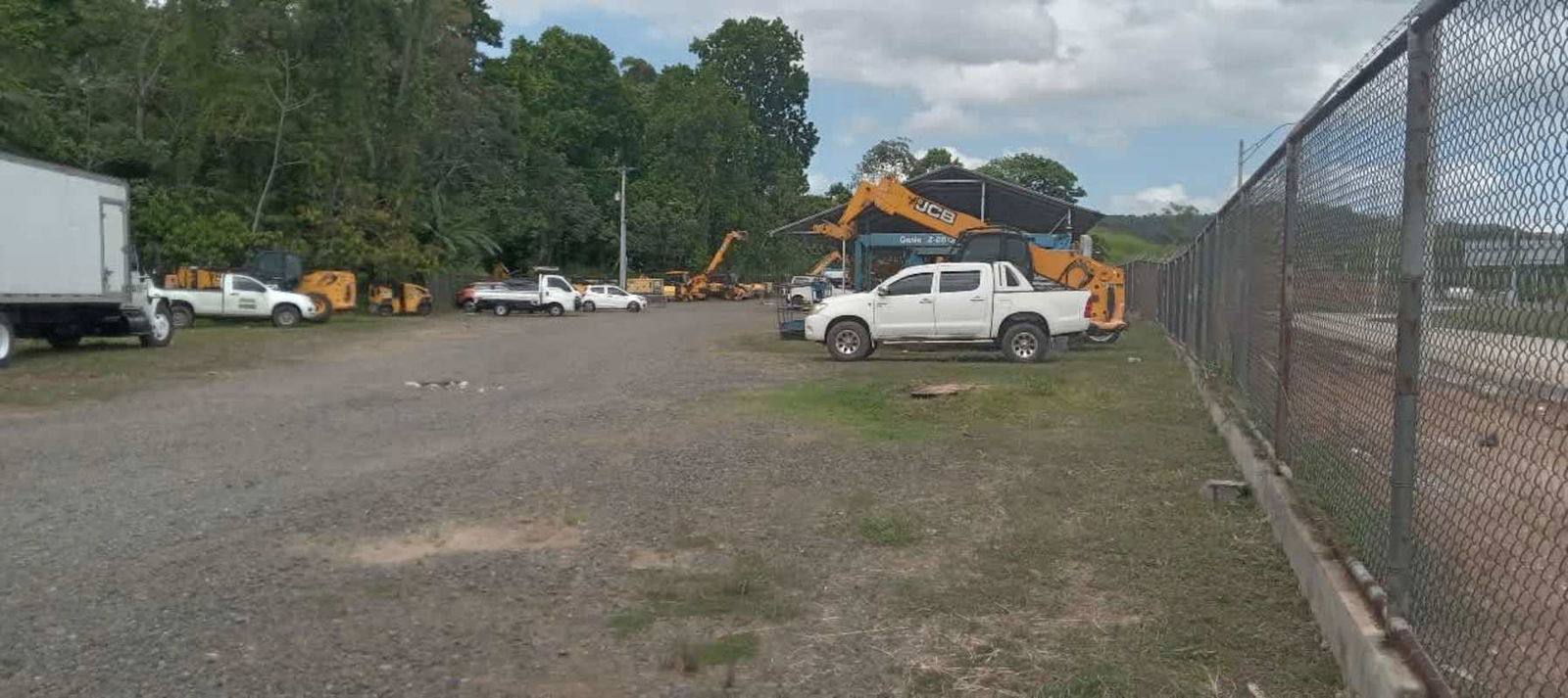 Secured gravel yard with truck parking and construction equipment storage in Pedregal Panama City