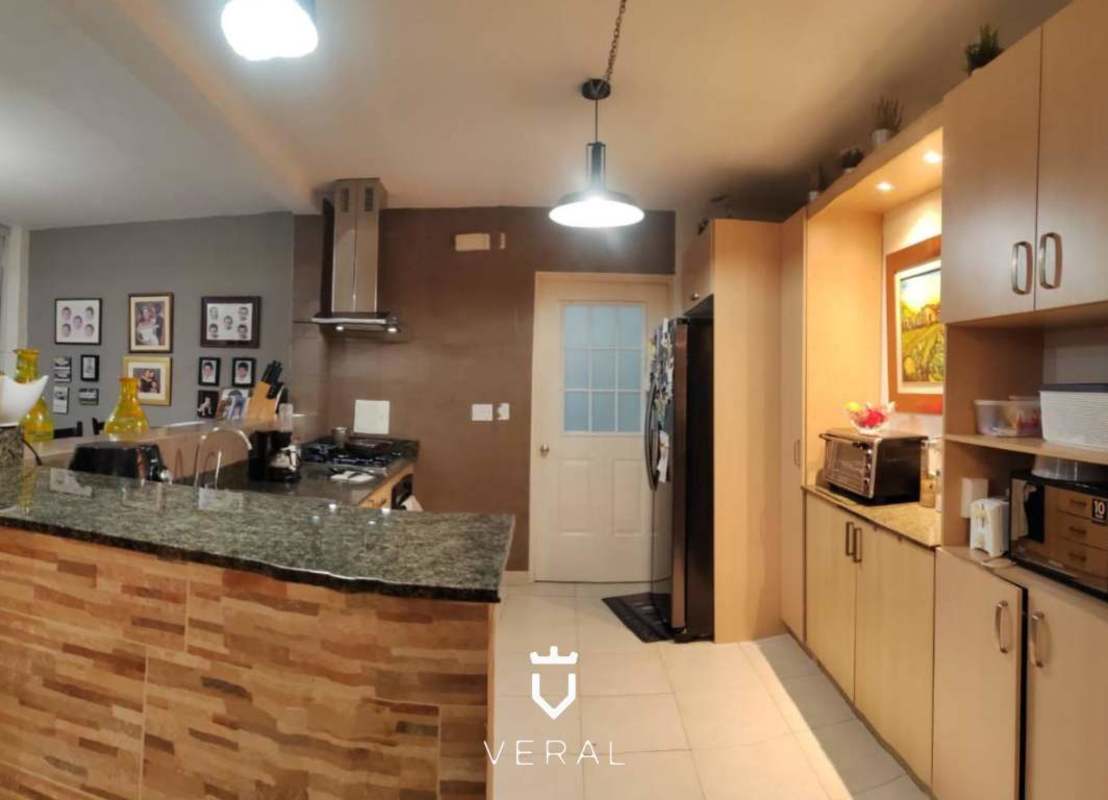 Remodeled kitchen with granite counters wood cabinetry breakfast bar in Versalles Panama Costa Sur