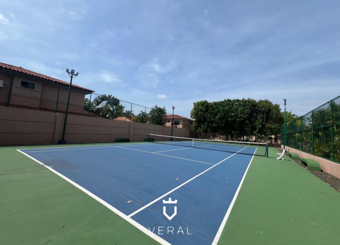 Private tennis court enclosed by fencing in Versalles Costa Sur Panama residential complex