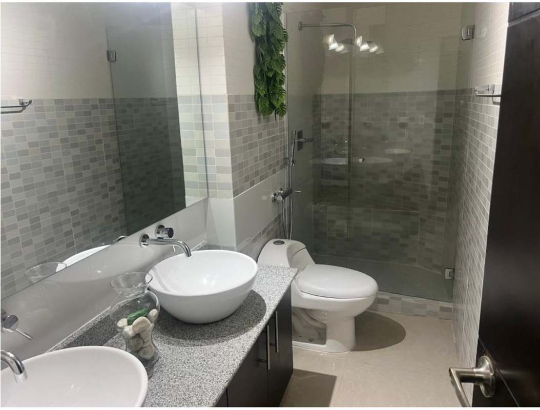 Modern bathroom with vessel sinks, granite counter, glass-enclosed shower Infinity Tower Panama