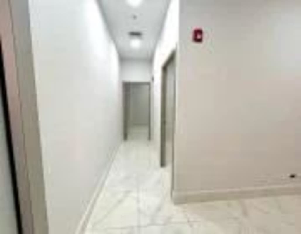 Bright hallway with marble tile floor and doorways PH Town Center Panama city